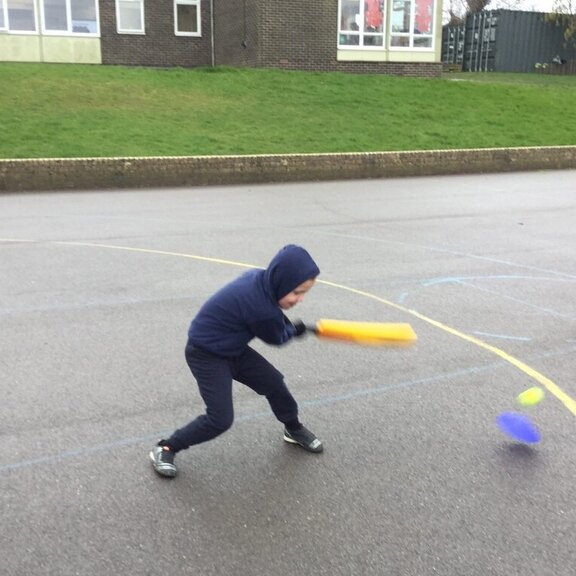 Boy practicing his cricket shot
