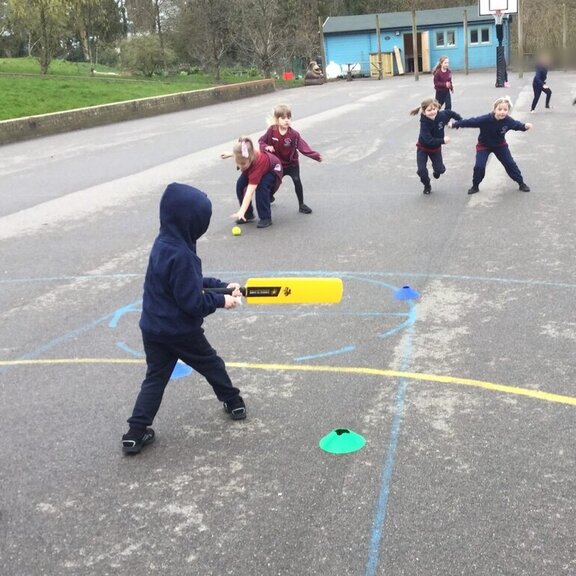 Playing cricket in the playground