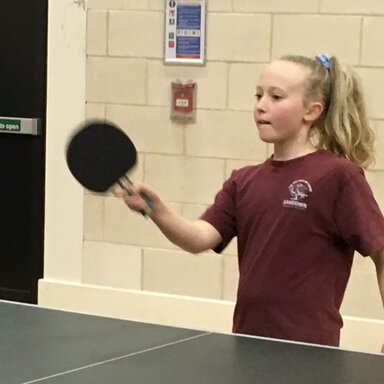 Girl concentrating on her table tennis shot