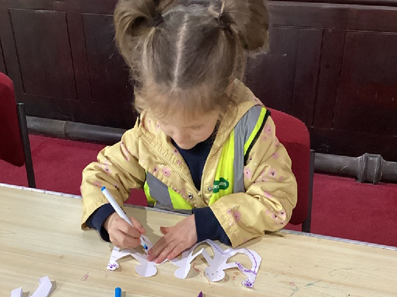 Child completing craft activity in church.