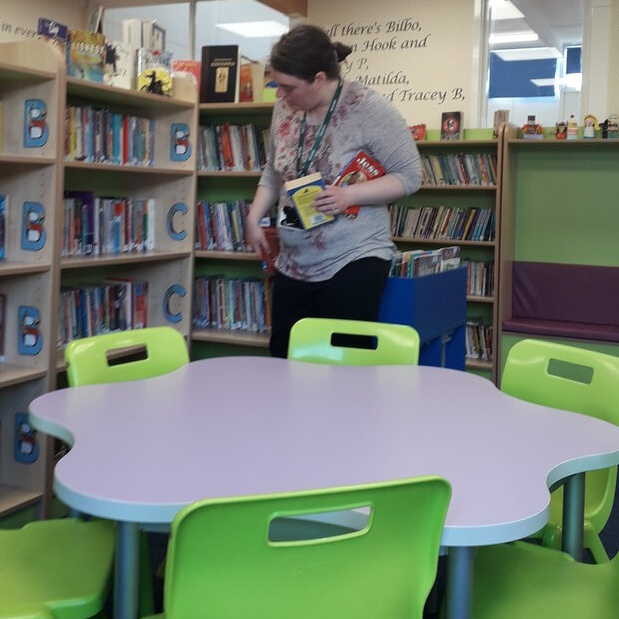 Emily putting books away in the library.